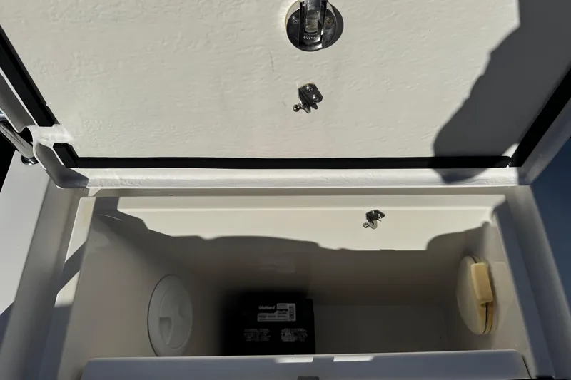 Slide: The Image of Open storage compartment on 2017 Axopar 37 Sun Top boat. - 18
