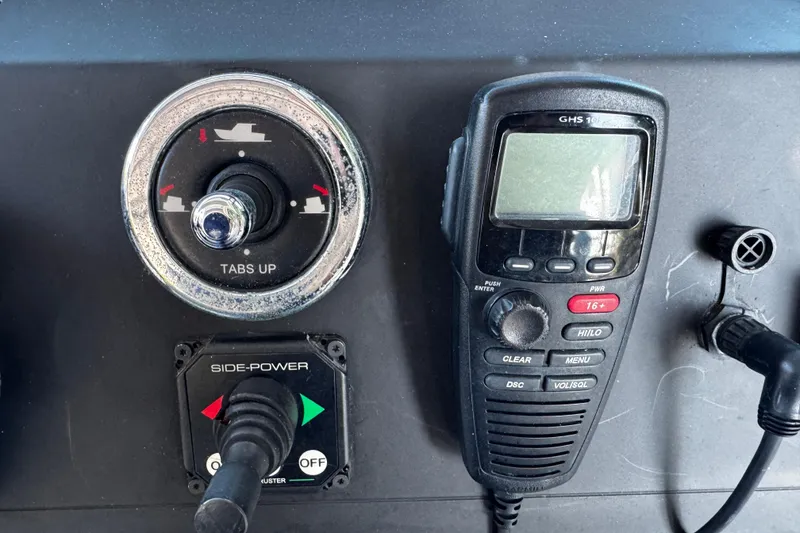 Slide: The Image of Control panel of a 2017 Axopar 37 Sun Top boat with radio and trim tabs. - 24