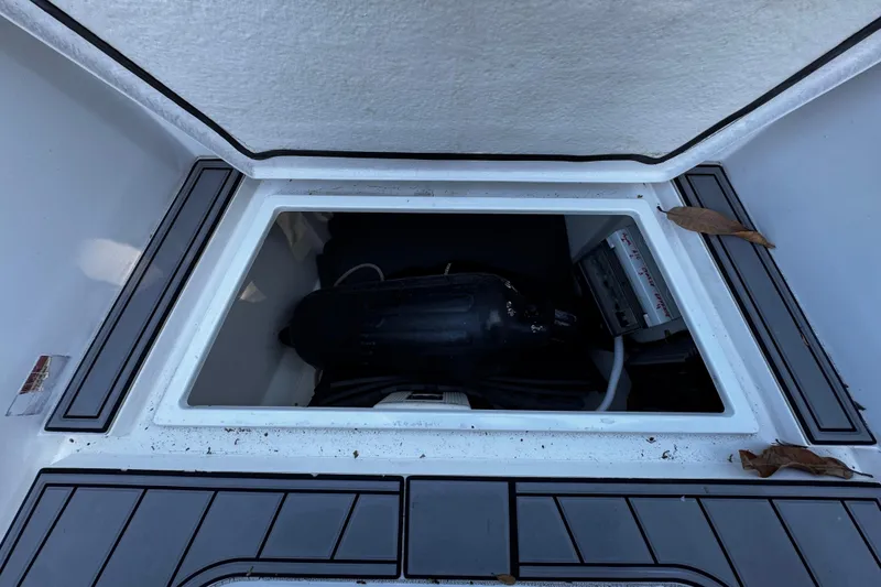 Slide: The Image of Open storage compartment on 2017 Axopar 37 Sun Top boat with visible equipment. - 36