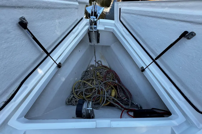 Slide: The Image of Open storage compartment on 2017 Axopar 37 Sun Top boat with ropes and equipment. - 38