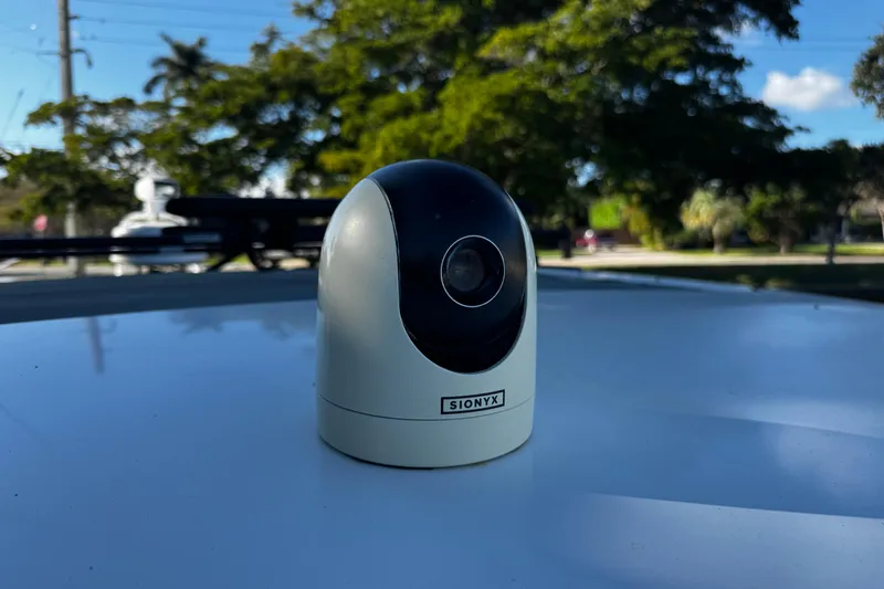 Slide: The Image of SIONYX camera on Axopar 37 Sun Top, 2017 model, with trees in the background. - 39