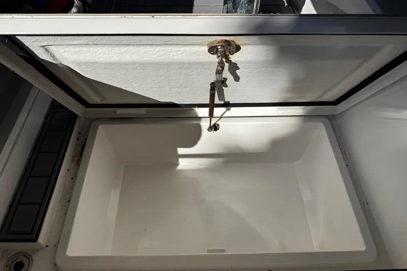 Slide: The Image of Open storage compartment on a 2017 Axopar 37 Sun Top boat, showing interior details. - 43