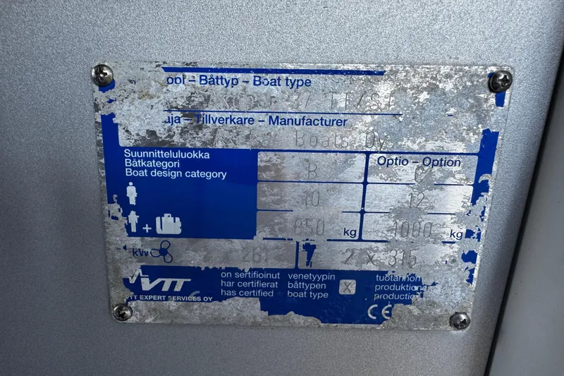 Slide: The Image of Weathered metal plate on 2017 Axopar 37 Sun Top boat, displaying specifications and certifications. - 47