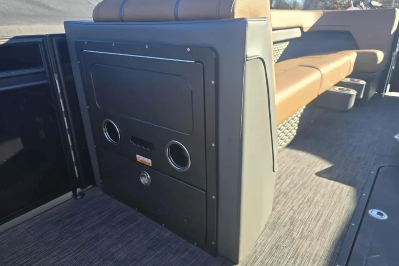 Slide: The Image of 2026 Qwest 8524 Q3XA boat interior with brown seating and storage compartment. - 14