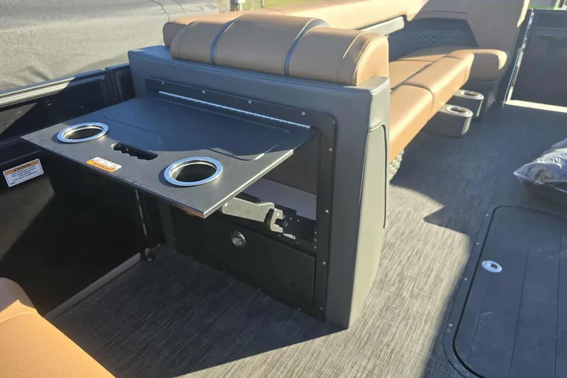 Slide: The Image of 2026 Qwest 8524 Q3XA boat interior with foldable table and cup holders. - 15