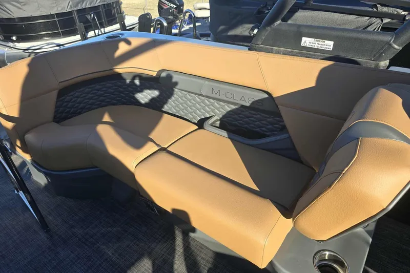 Slide: The Image of Luxurious seating on 2026 Qwest 8524 Q3XA boat with tan upholstery and M-Class branding. - 16