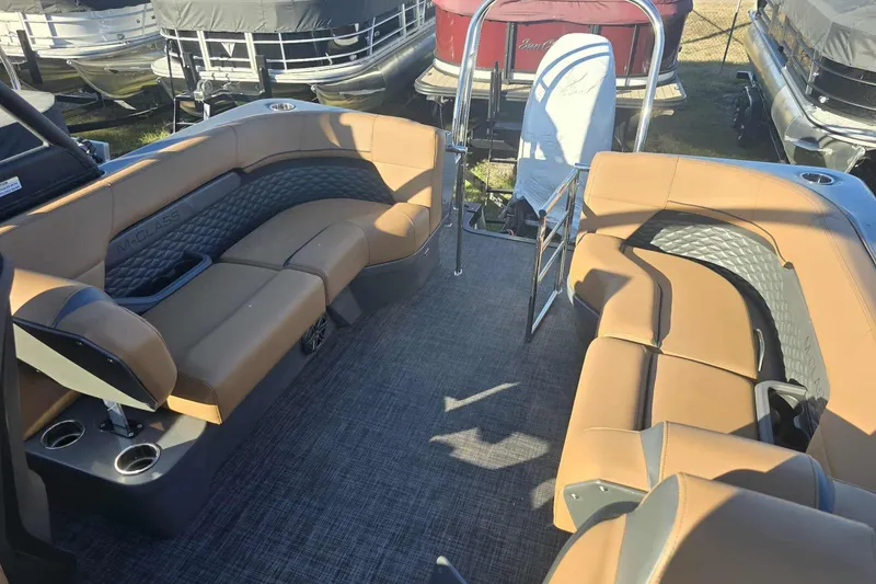 Slide: The Image of Luxurious interior of 2026 Qwest 8524 Q3XA pontoon boat with tan seating and cup holders. - 17