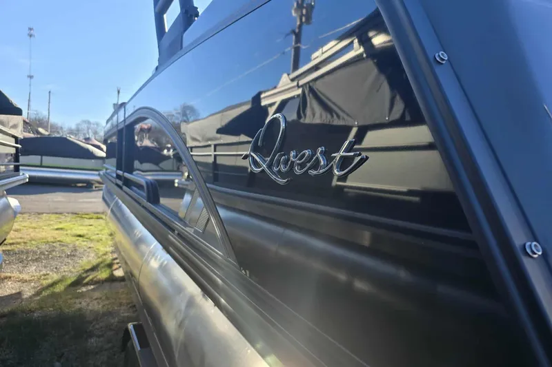 Slide: The Image of 2026 Qwest 8524 Q3XA boat with sleek black exterior and chrome logo. - 3