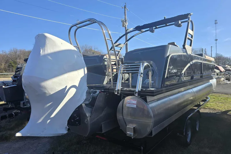 Slide: The Image of 2026 Qwest 8524 Q3XA pontoon boat with covered engine, parked outdoors. - 7