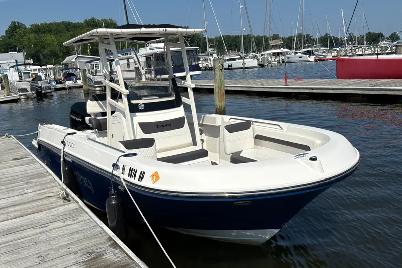 Slide: The Image of 2024 Trophy CC22 boat docked at marina, featuring sleek design and spacious seating. - 2