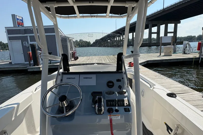 Slide: The Image of 2024 Trophy CC22 boat at dock, featuring steering console and waterfront view. - 3