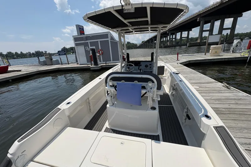 Slide: The Image of 2024 Trophy CC22 boat docked at marina, under a bridge, with clear skies. - 5