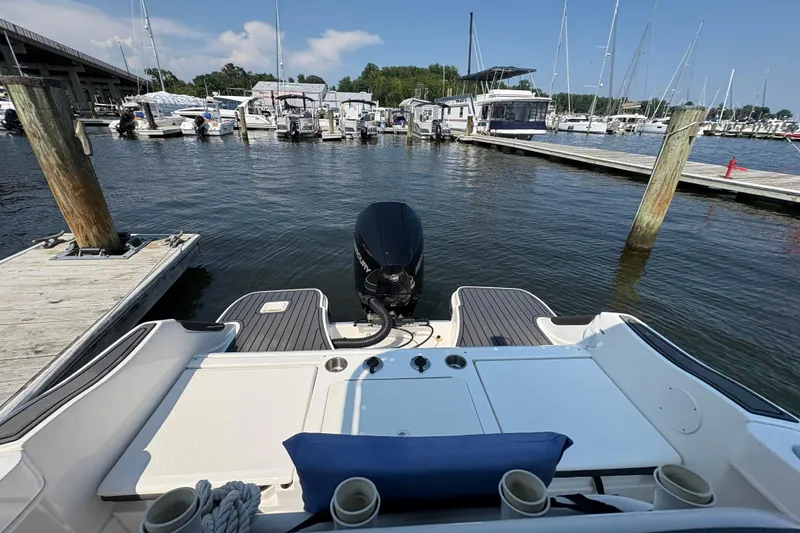 Slide: The Image of 2024 Trophy CC22 boat docked at marina, featuring outboard motor and spacious deck. - 6