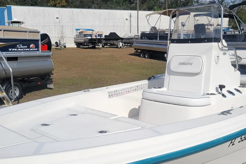 Slide: The Image of 2011 Sundance SV186 boat displayed outdoors with other boats in the background. - 4