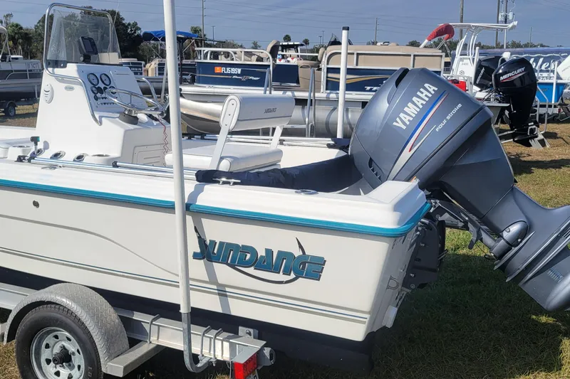 Slide: The Image of 2011 Sundance SV186 boat with Yamaha outboard motor on trailer, displayed outdoors. - 6
