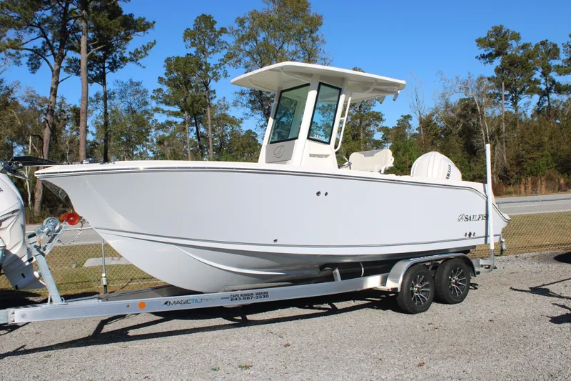The Image of 2026 Sailfish 232 CC boat on trailer, parked outdoors on a sunny day. - 0