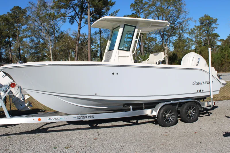 Slide: The Image of 2026 Sailfish 232 CC boat on trailer, parked outdoors, side view. - 1