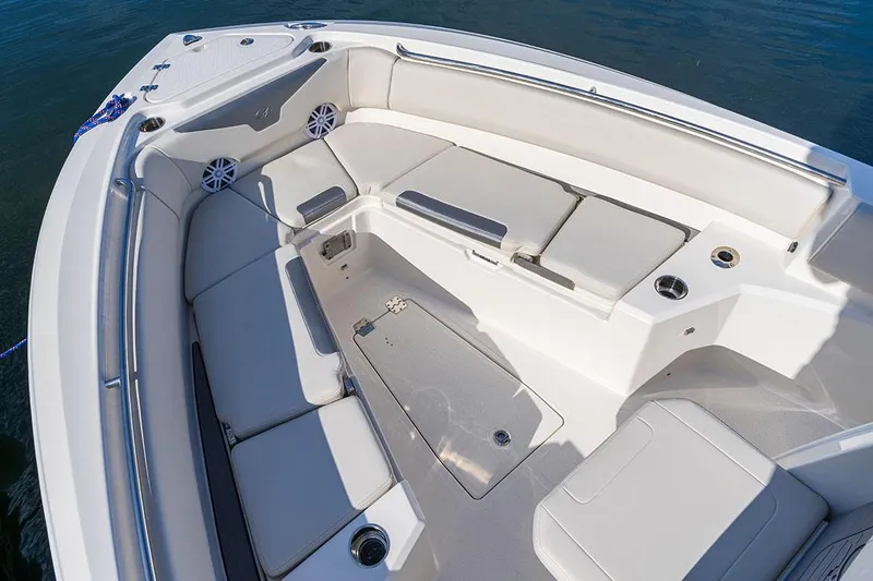 Slide: The Image of Manufacturer Provided Image: 2026 Sailfish 232 CC boat interior with cushioned seating and cup holders on calm water. - 13