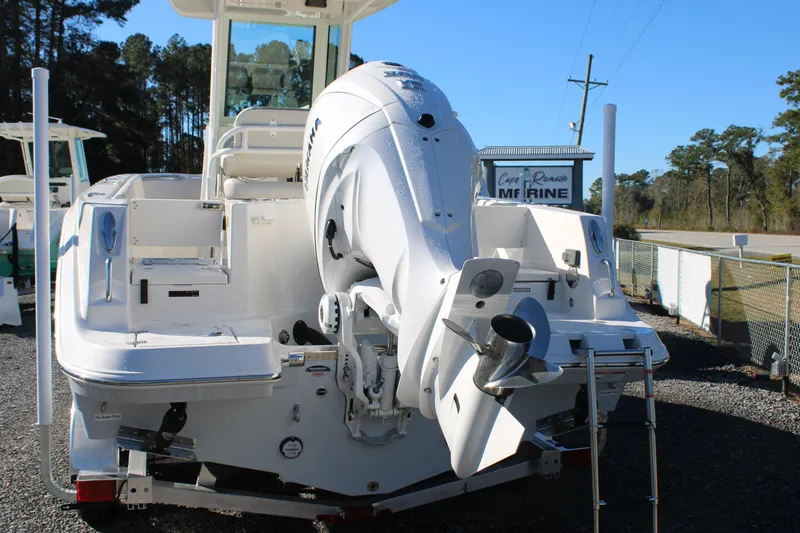 Slide: The Image of 2026 Sailfish 232 CC boat with powerful outboard motor, displayed outdoors. - 2