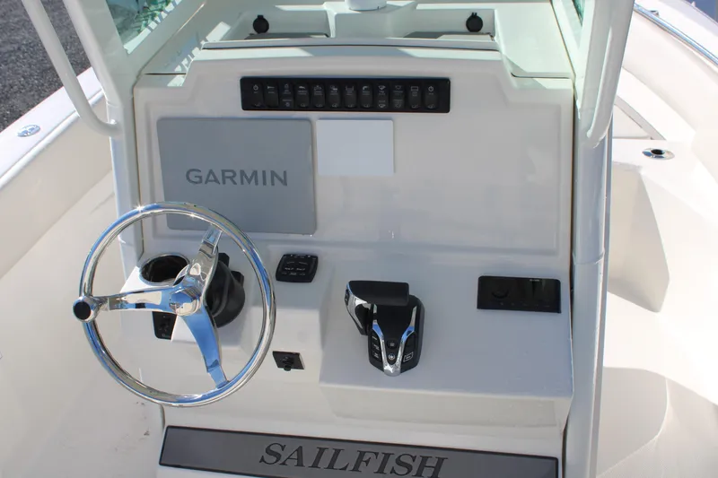 Slide: The Image of 2026 Sailfish 232 CC boat console with Garmin navigation and steering wheel. - 21
