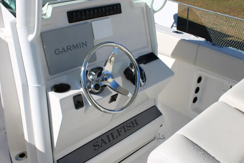 Slide: The Image of 2026 Sailfish 232 CC boat helm with Garmin navigation system and sleek steering wheel. - 24