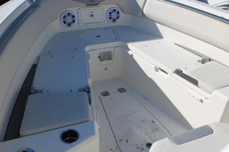 Slide: The Image of Interior view of 2026 Sailfish 232 CC boat, featuring seating and storage compartments. - 26