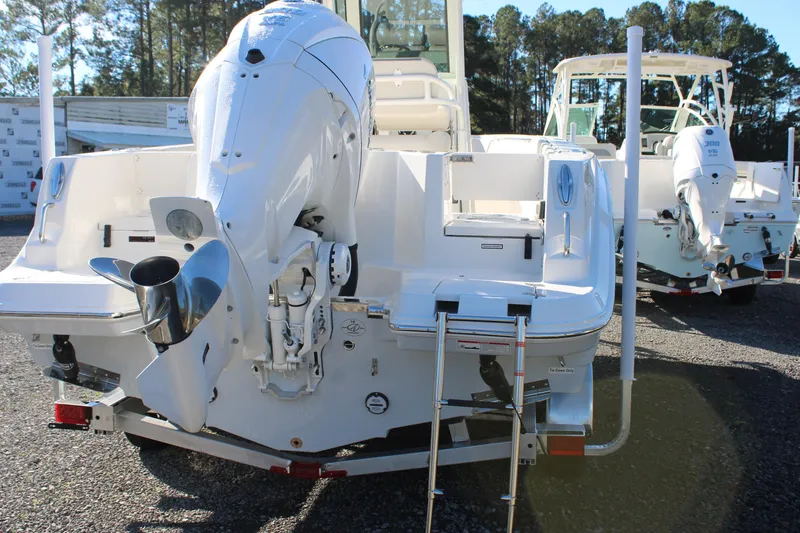 Slide: The Image of 2026 Sailfish 232 CC boat with powerful outboard motor, parked on a trailer. - 3