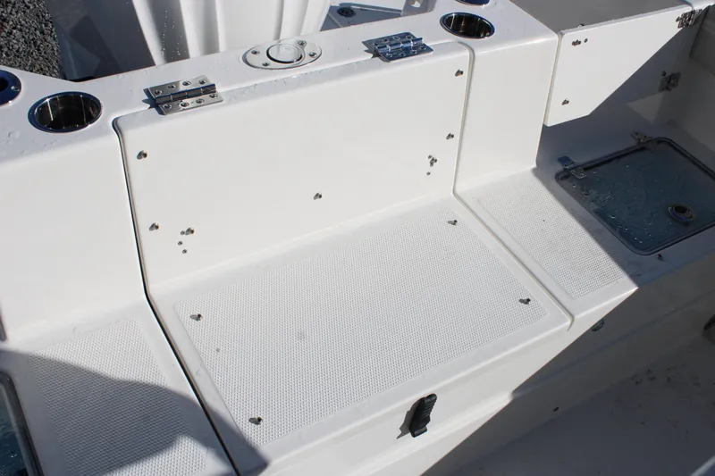 Slide: The Image of 2026 Sailfish 232 CC boat interior with storage compartments and cup holders. - 36