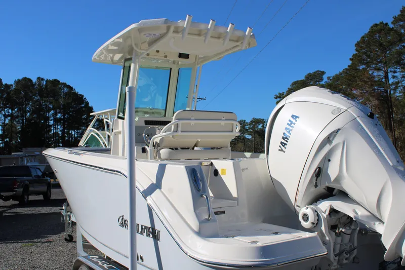 Slide: The Image of 2026 Sailfish 232 CC boat with Yamaha engine, parked outdoors under clear blue sky. - 4