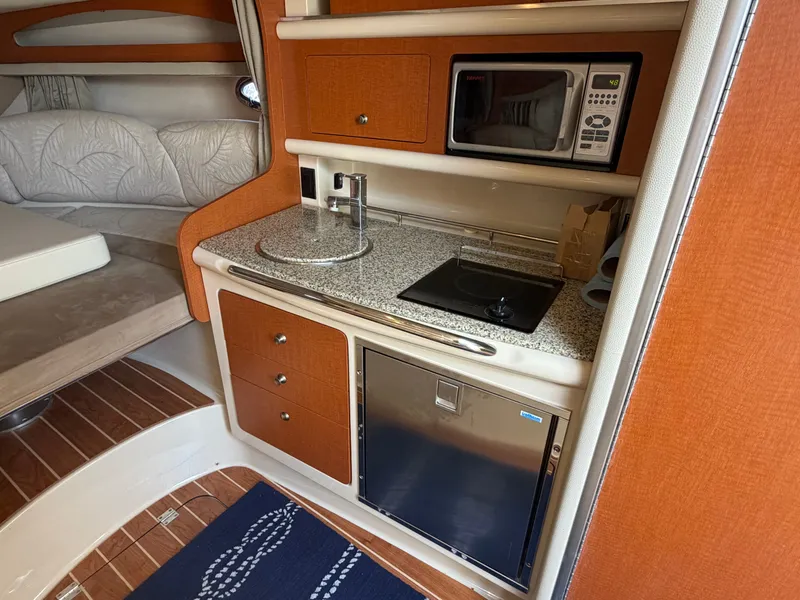 Slide: The Image of Interior of 2005 Chaparral 290 Signature with kitchenette and sleeping area. - 18