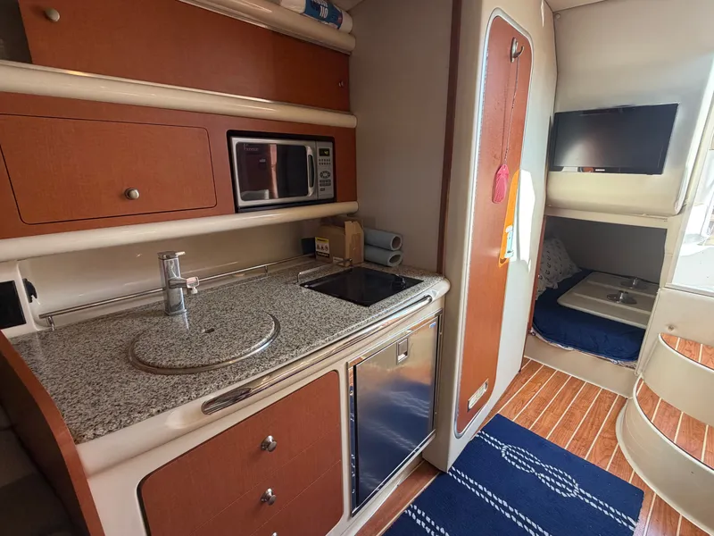 Slide: The Image of Interior of 2005 Chaparral 290 Signature with kitchen and sleeping area. - 20