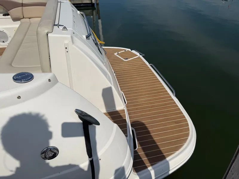 Slide: The Image of Rear view of a 2005 Chaparral 290 Signature boat by the water. - 5