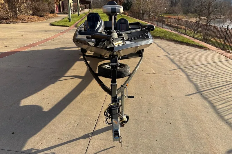 Slide: The Image of 2017 Ranger RT178C boat on trailer, parked on a sunny driveway near a lake. - 10
