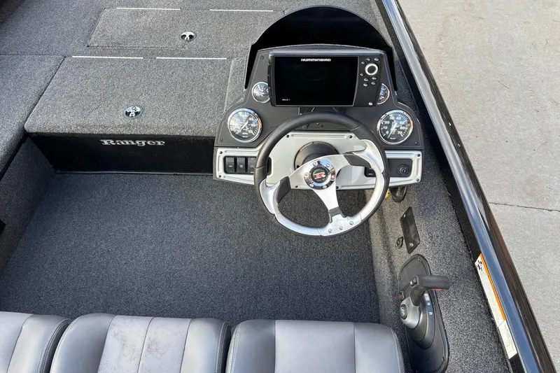 Slide: The Image of 2017 Ranger RT178C boat cockpit with steering wheel and control panel. - 13