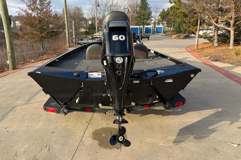 Slide: The Image of 2017 Ranger RT178C boat with Mercury 60 engine, parked on a concrete surface. - 8