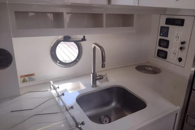 Slide: The Image of Modern kitchen area in 2023 Evolve 400HT with sink, faucet, and control panel. - 18