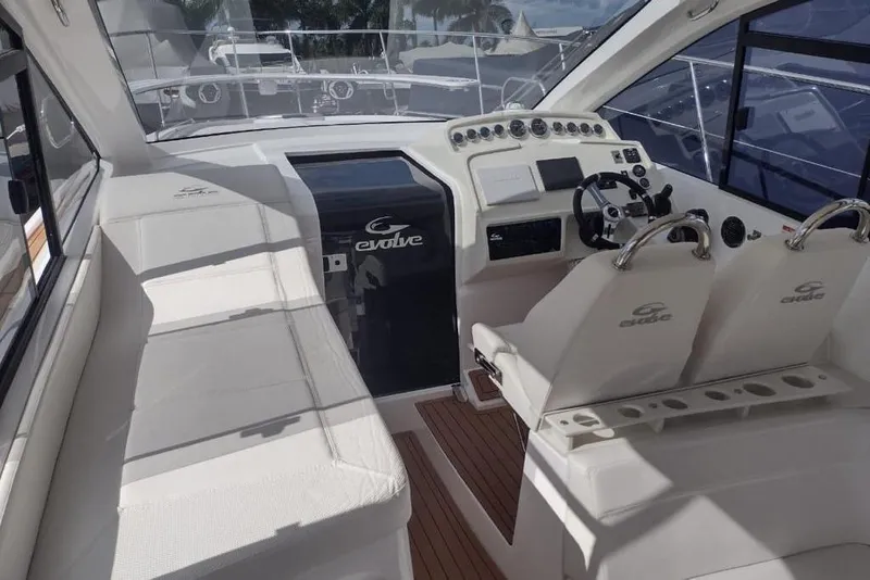 Slide: The Image of 2023 Evolve 400HT yacht interior with sleek white seating and modern control panel. - 22