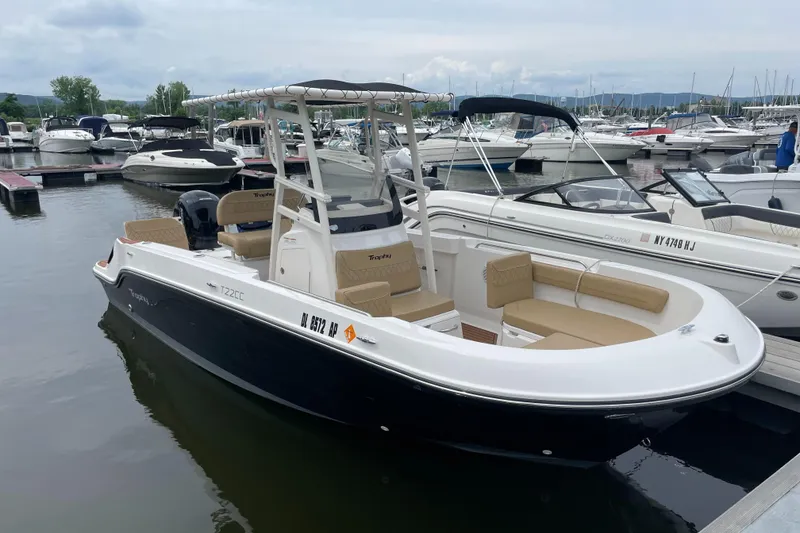 Slide: The Image of 2024 Trophy CC22 boat docked at marina, featuring sleek design and comfortable seating. - 3