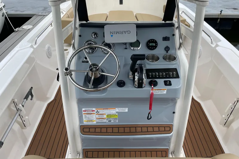 Slide: The Image of 2024 Trophy CC22 boat helm with steering wheel, controls, and Garmin navigation system. - 4