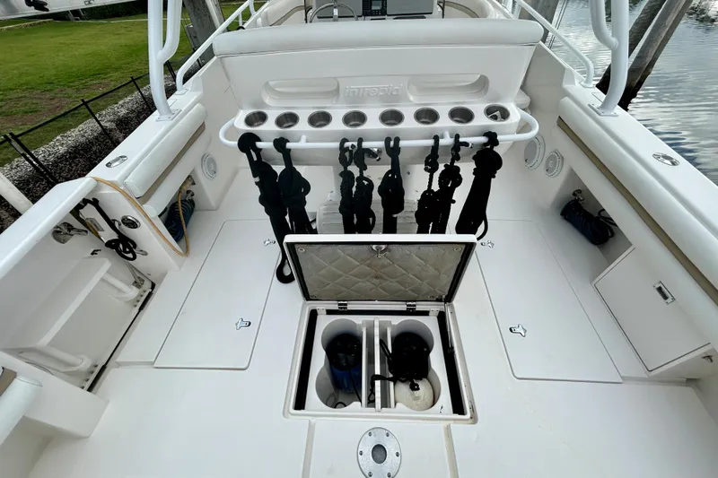 Slide: The Image of 2012 Intrepid 400 Cuddy boat deck with storage and fishing rod holders. - 11