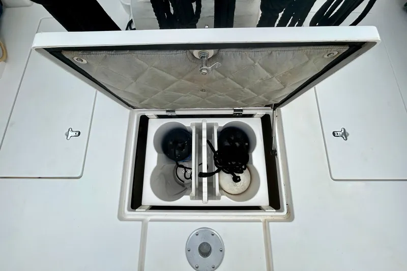 Slide: The Image of Open storage compartment on 2012 Intrepid 400 Cuddy boat deck. - 12