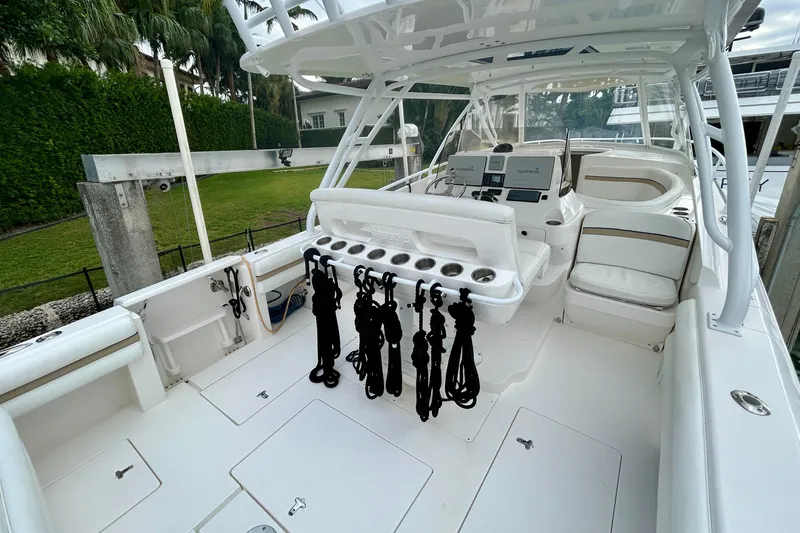 Slide: The Image of 2012 Intrepid 400 Cuddy boat interior with seating and navigation equipment. - 13