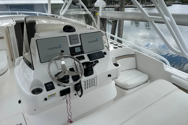 Slide: The Image of 2012 Intrepid 400 Cuddy helm with Garmin navigation, sleek design, and comfortable seating. - 15