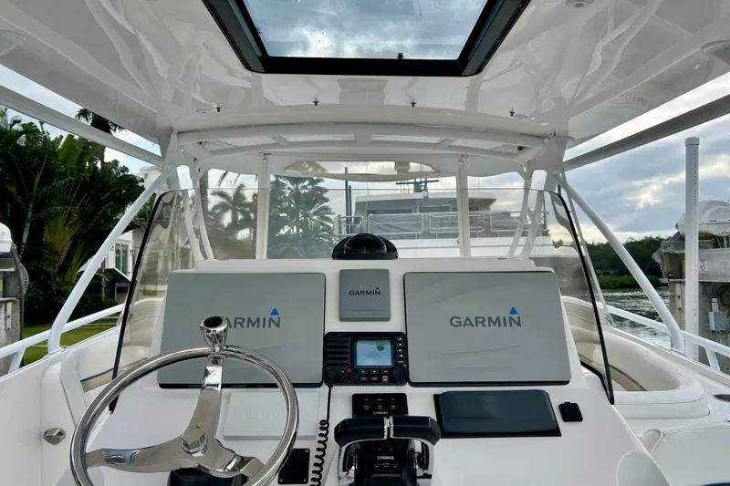 Slide: The Image of Cockpit of 2012 Intrepid 400 Cuddy with Garmin navigation system and sleek steering wheel. - 16