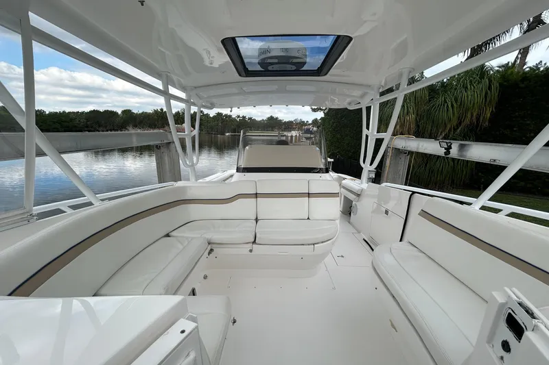 Slide: The Image of 2012 Intrepid 400 Cuddy boat interior with white seating and open canopy. - 20