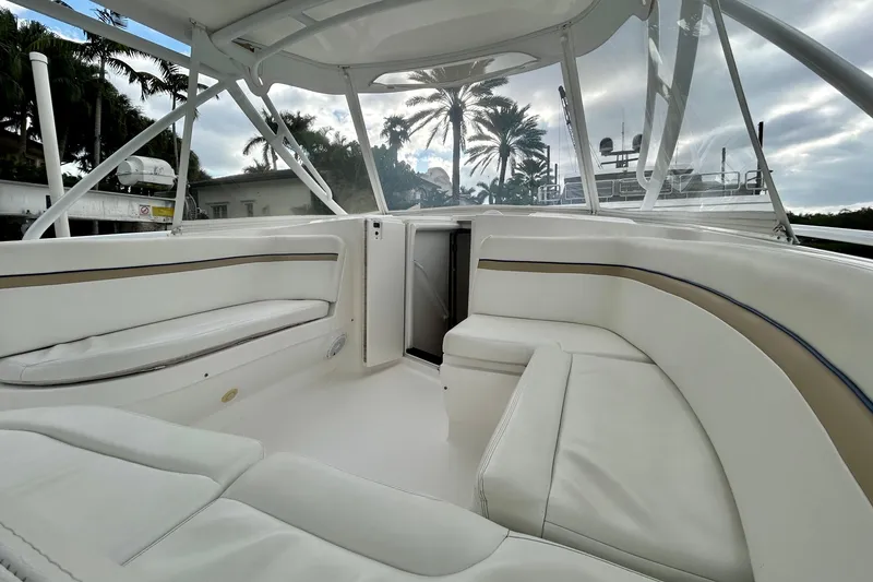 Slide: The Image of Luxurious interior of 2012 Intrepid 400 Cuddy boat with white seating and palm trees. - 22
