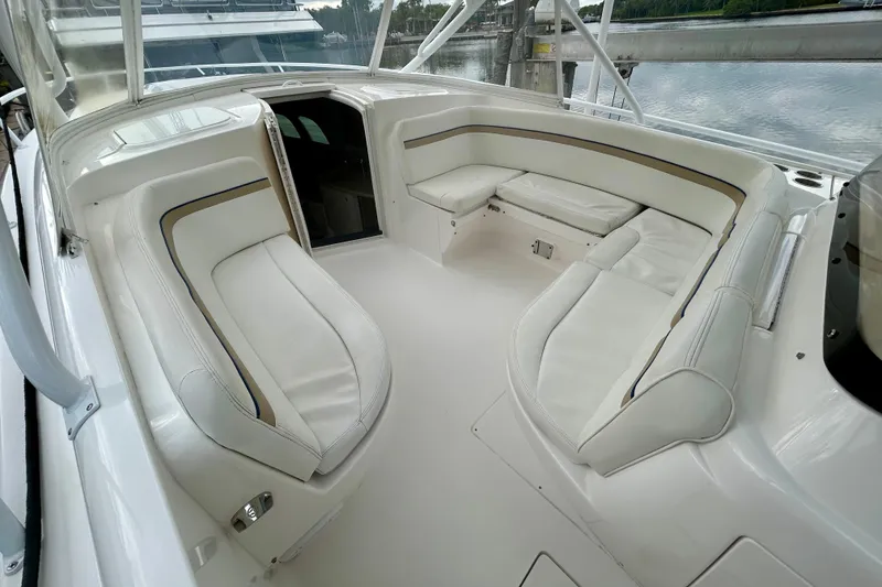 Slide: The Image of 2012 Intrepid 400 Cuddy boat interior with white cushioned seating and open cabin. - 23