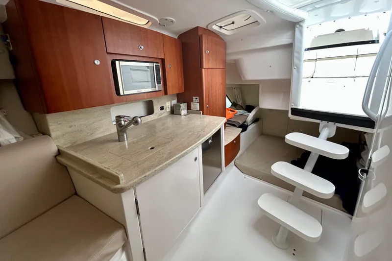 Slide: The Image of Luxurious 2012 Intrepid 400 Cuddy interior with modern kitchen and cozy seating area. - 24