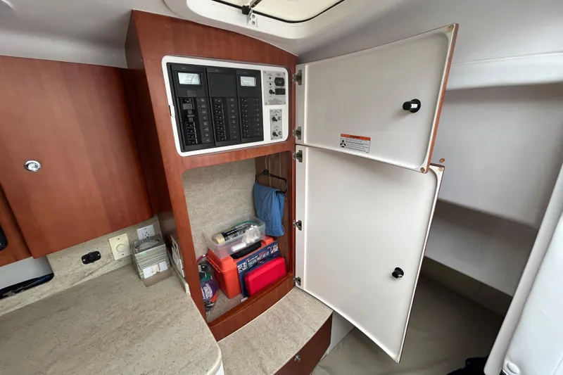 Slide: The Image of 2012 Intrepid 400 Cuddy interior with open cabinet and electrical panel. - 27