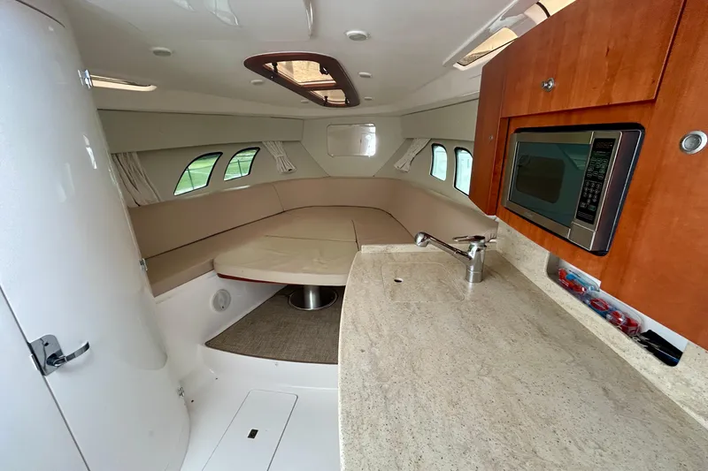 Slide: The Image of Luxurious 2012 Intrepid 400 Cuddy interior with kitchenette and cozy seating area. - 28